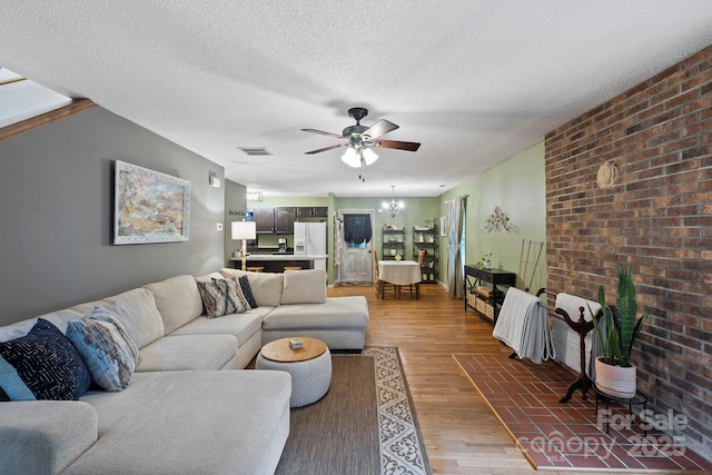 10 Kettle Creek Ln, Brevard, NC 28712 - living room featuring ceiling fan, wood finished floors, brick wall, and a textured ceiling