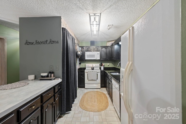 10 Kettle Creek Ln, Brevard, NC 28712 - kitchen featuring white appliances, a textured ceiling, and a sink