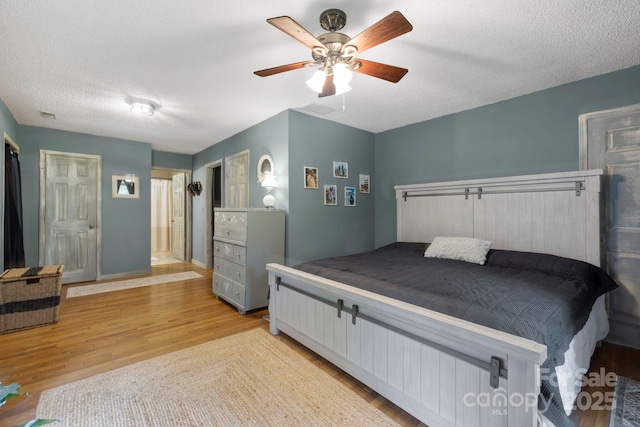 10 Kettle Creek Ln, Brevard, NC 28712 - bedroom with wood finished floors, ceiling fan, baseboards, and a textured ceiling