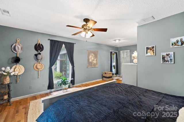 10 Kettle Creek Ln, Brevard, NC 28712 - bedroom with wood finished floors, a textured ceiling, baseboards, and a ceiling fan