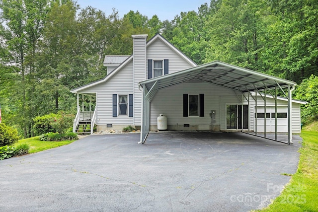 10 Kettle Creek Ln, Brevard, NC 28712 - view of front of home featuring a carport, a chimney, driveway, and crawl space