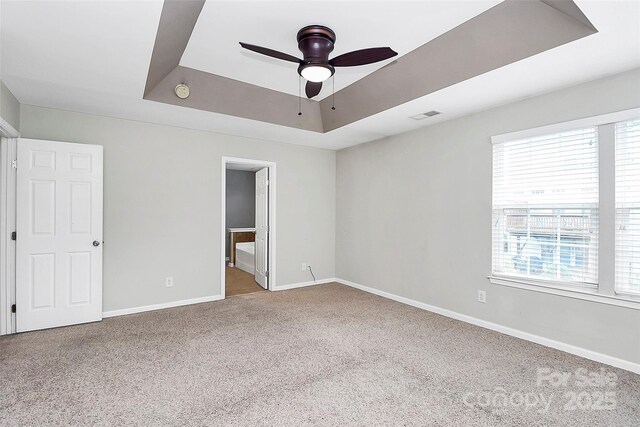 3251 Park S Station Blvd, Charlotte, NC 28210 - unfurnished bedroom with a raised ceiling, carpet flooring, multiple windows, and baseboards