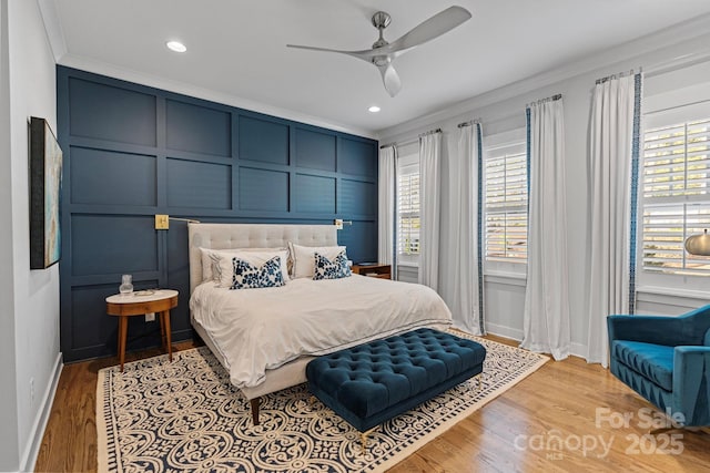 1502 Matthew Mcclure Cir, Davidson, NC 28036 - bedroom with a decorative wall, multiple windows, ornamental molding, light wood-type flooring, and recessed lighting