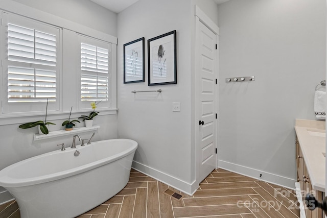 1502 Matthew Mcclure Cir, Davidson, NC 28036 - bathroom featuring a freestanding bath, vanity, and baseboards