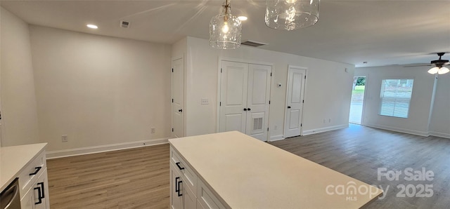 office area with wood finished floors, baseboards, ceiling fan, recessed lighting, and a chandelier