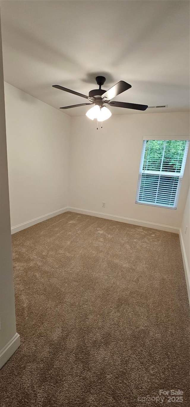 unfurnished room with carpet, ceiling fan, and baseboards
