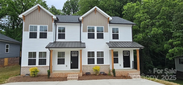 view of front of home with board and batten siding, a standing seam roof, metal roof, and a porch