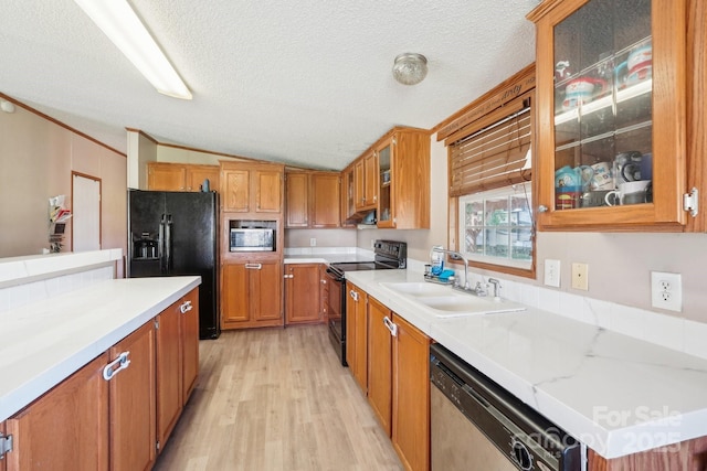 4122 Canal Rd, Marshville, NC 28103 - kitchen featuring black appliances, a sink, lofted ceiling, brown cabinets, and light wood-style flooring