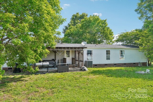 4122 Canal Rd, Marshville, NC 28103 - back of property with crawl space, a lawn, and an outdoor hangout area