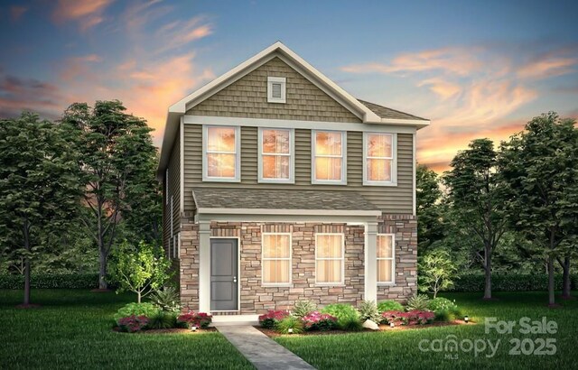 view of front of house with stone siding and a lawn