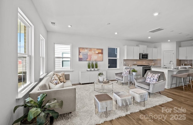 living room featuring wood finished floors and recessed lighting