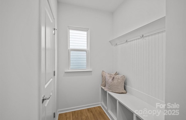 mudroom with wood finished floors and baseboards
