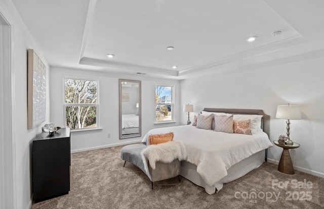 bedroom with a tray ceiling, carpet flooring, baseboards, and recessed lighting