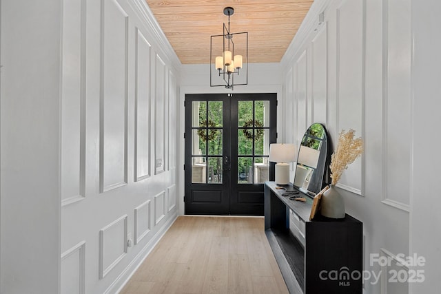 9564 Regent Dr, Davidson, NC 28036 - doorway to outside featuring a decorative wall, french doors, light wood-type flooring, wood ceiling, and a chandelier