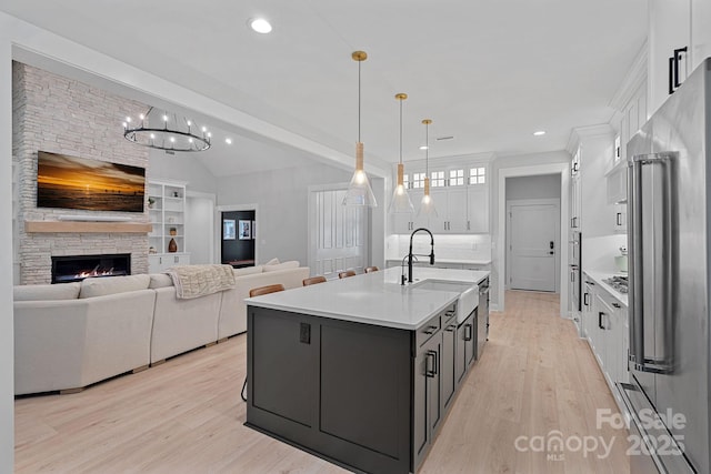 9564 Regent Dr, Davidson, NC 28036 - kitchen with appliances with stainless steel finishes, white cabinets, vaulted ceiling, a sink, and light countertops