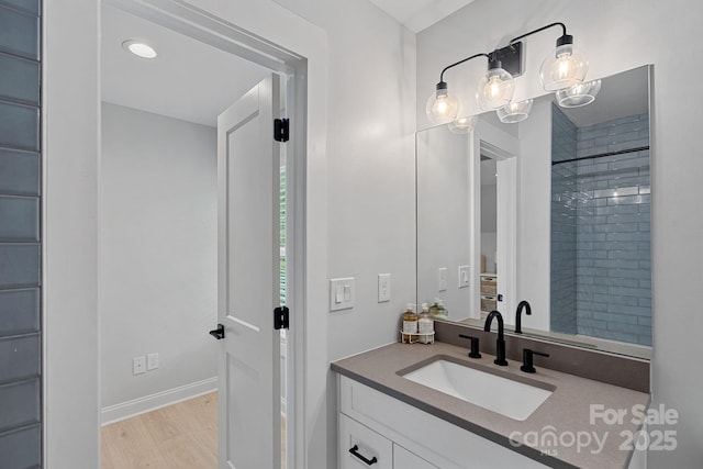 9564 Regent Dr, Davidson, NC 28036 - bathroom with wood finished floors, vanity, and baseboards