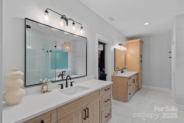 9564 Regent Dr, Davidson, NC 28036 - full bath featuring marble look tile flooring, a shower stall, two vanities, baseboards, and recessed lighting