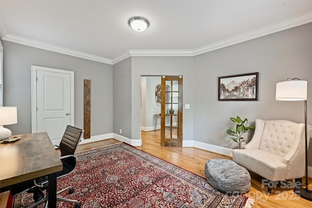 office space with ornamental molding, wood finished floors, and baseboards