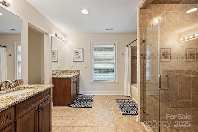 full bathroom with a shower stall, two vanities, tile patterned floors, baseboards, and recessed lighting