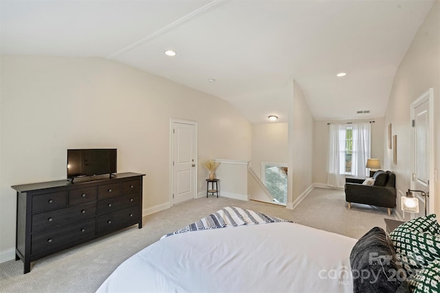 carpeted bedroom with vaulted ceiling and baseboards