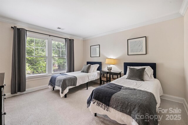 bedroom featuring crown molding, baseboards, and carpet