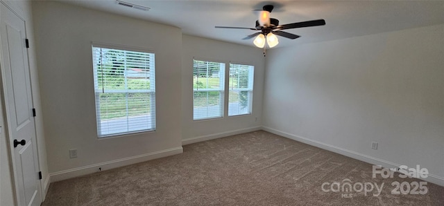 spare room with carpet flooring, a ceiling fan, and baseboards