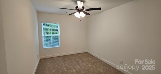 carpeted spare room with baseboards and a ceiling fan