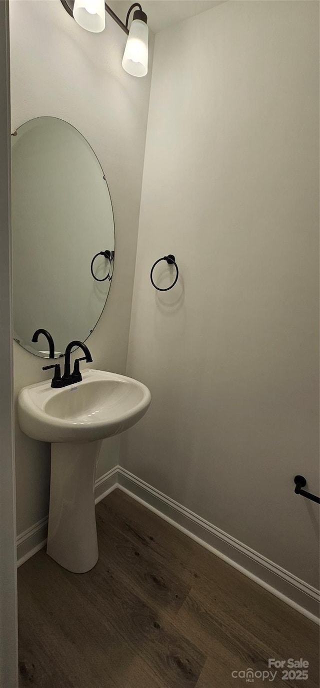 bathroom featuring baseboards and wood finished floors