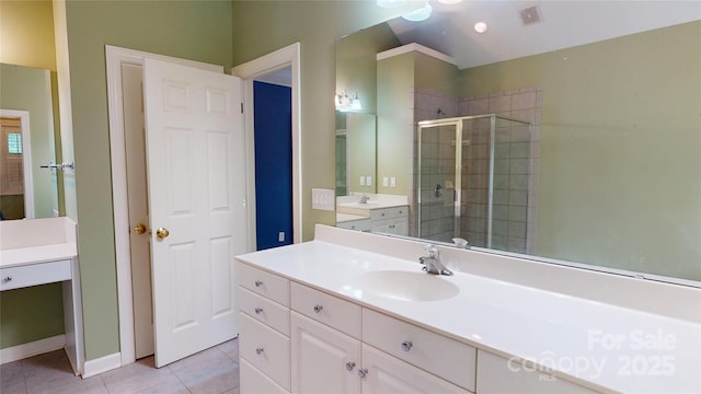 full bathroom with tile patterned floors, a stall shower, baseboards, and vanity
