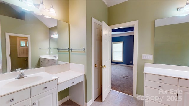 bathroom with tile patterned floors, baseboards, and vanity
