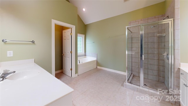 bathroom with vaulted ceiling, a stall shower, a bath, tile patterned flooring, and vanity