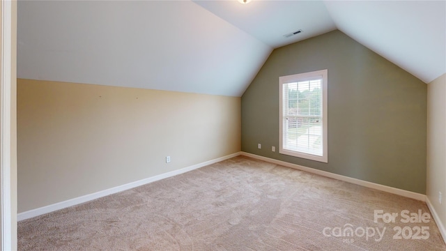 bonus room featuring vaulted ceiling, carpet floors, and baseboards