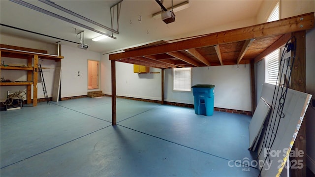 garage with a garage door opener and baseboards