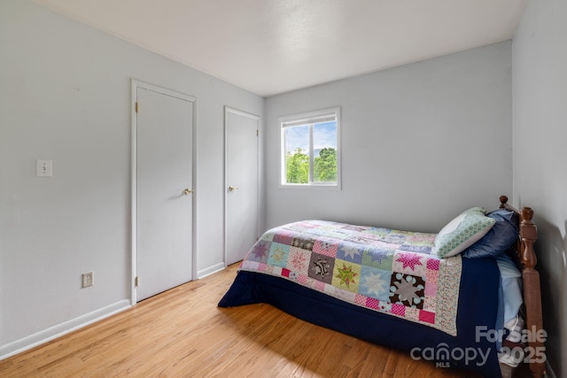 bedroom featuring wood finished floors and baseboards