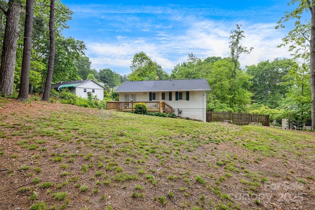 rear view of house featuring a wooden deck