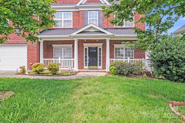 6227 Castlecove Rd, Charlotte, NC 28278 - view of front of home with brick siding, a porch, a front yard, driveway, and an attached garage
