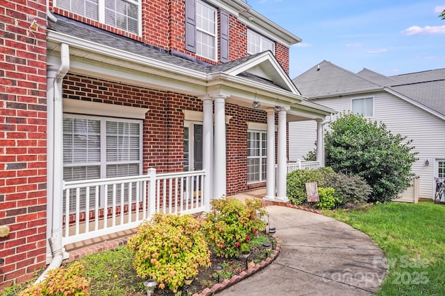 6227 Castlecove Rd, Charlotte, NC 28278 - doorway to property with brick siding and a porch