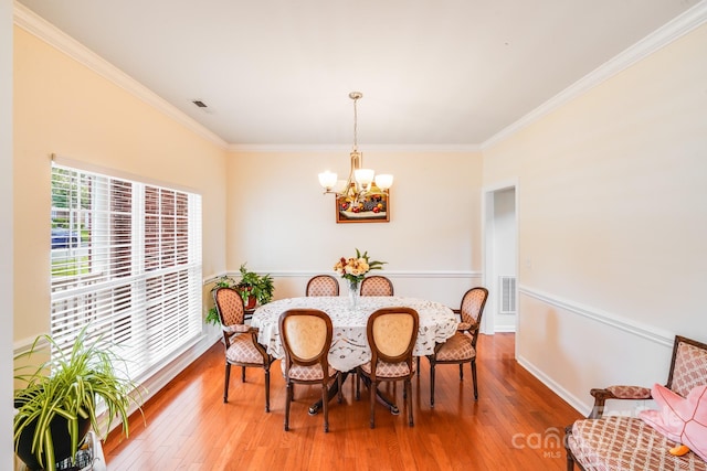 6227 Castlecove Rd, Charlotte, NC 28278 - dining room with a chandelier, ornamental molding, and light wood finished floors