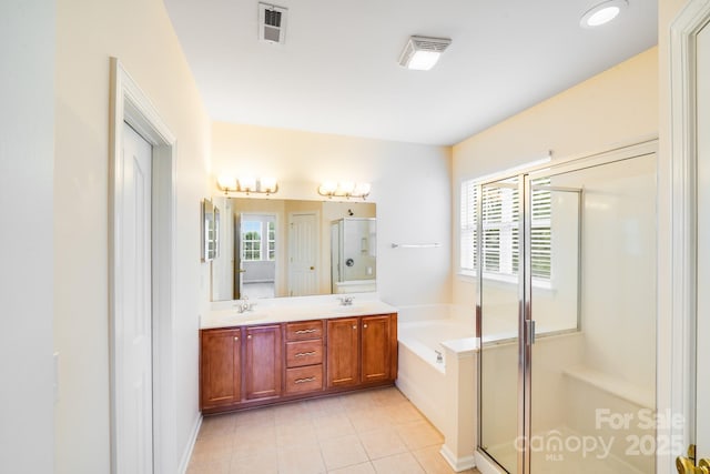 6227 Castlecove Rd, Charlotte, NC 28278 - full bath with a stall shower, double vanity, a garden tub, and tile patterned floors