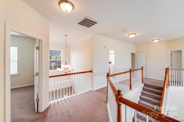 6227 Castlecove Rd, Charlotte, NC 28278 - hall with a chandelier, carpet, an upstairs landing, and ornamental molding