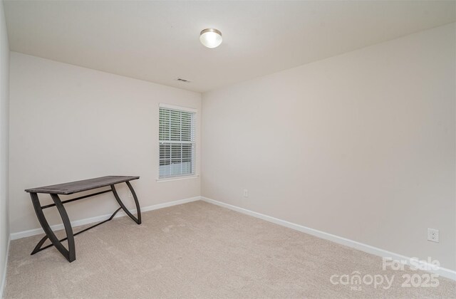carpeted spare room with baseboards