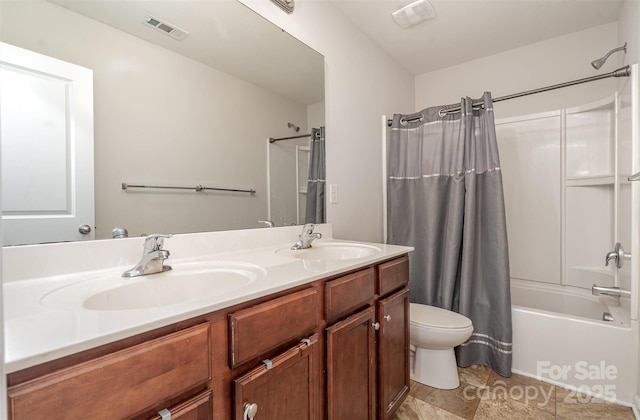 bathroom featuring shower / bathtub combination with curtain, toilet, double vanity, and tile patterned flooring