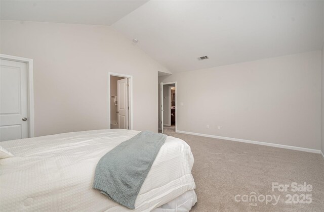 bedroom with lofted ceiling, carpet flooring, and baseboards