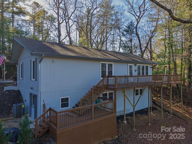 rear view of house with stairs, a wooden deck, cooling unit, and a shingled roof