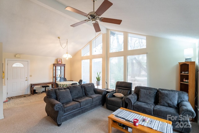carpeted living room featuring a ceiling fan and high vaulted ceiling