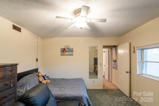 bedroom featuring carpet floors, a textured ceiling, ceiling fan, and baseboards