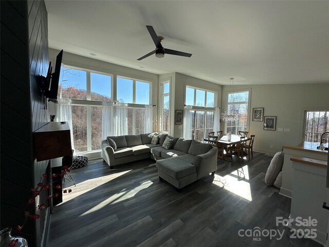 3149 Winter Hawk Ln, Lenoir, NC 28645 - living room featuring healthy amount of natural light, dark wood-style flooring, ceiling fan, and baseboards