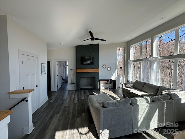 3149 Winter Hawk Ln, Lenoir, NC 28645 - living room featuring a large fireplace, dark wood-style floors, a ceiling fan, and baseboards