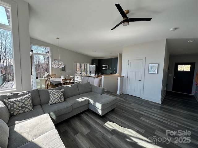 3149 Winter Hawk Ln, Lenoir, NC 28645 - living area with dark wood-type flooring, a ceiling fan, vaulted ceiling, baseboards, and a chandelier