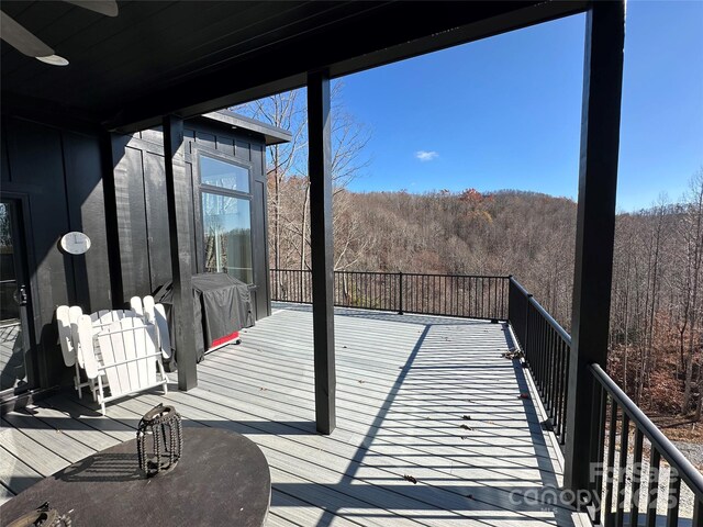 3149 Winter Hawk Ln, Lenoir, NC 28645 - wooden deck with a wooded view and a ceiling fan
